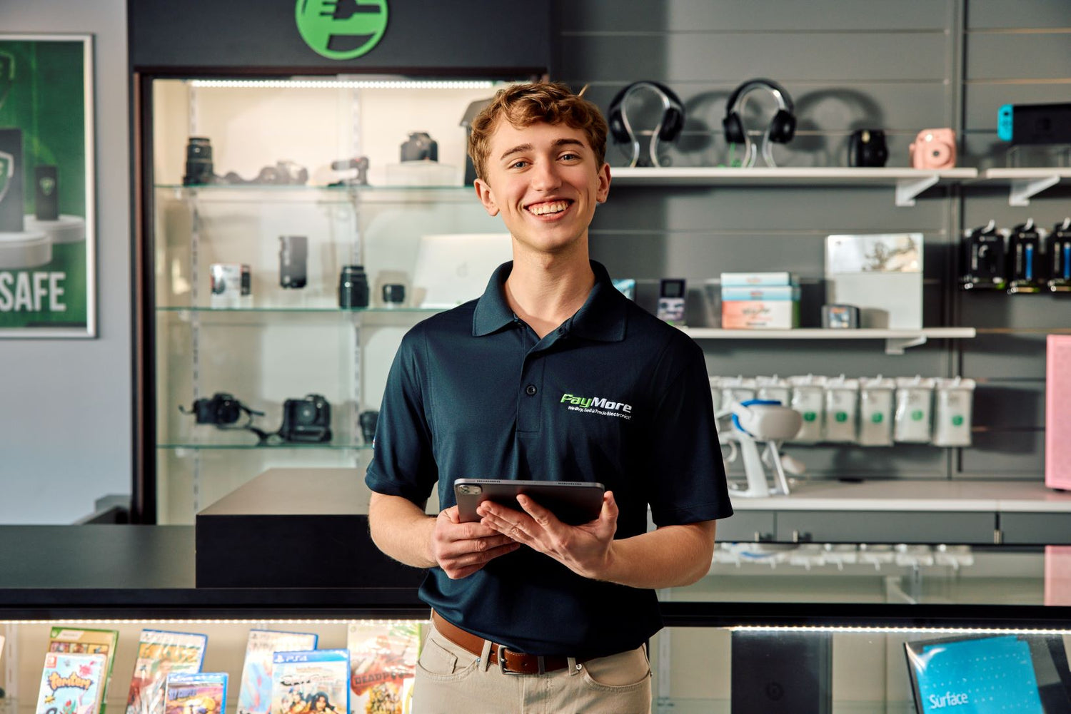 paymore employee holding a tablet and smiling